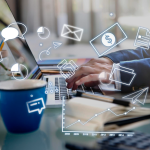 Person working on a laptop with digital marketing icons.