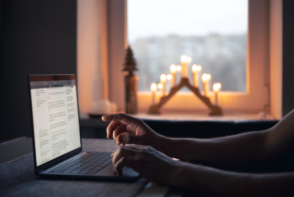 Person using a laptop by candlelight.